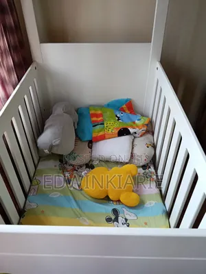 White Baby Crib With Colorful Circle Design