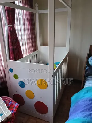 White Baby Crib With Colorful Circle Design