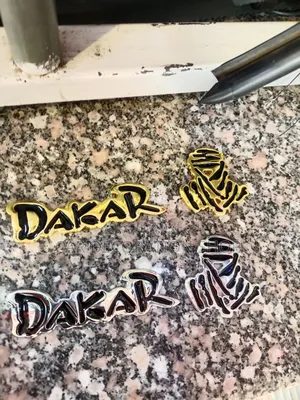 Dakar Metallic Badge in Gold or Silver (Each