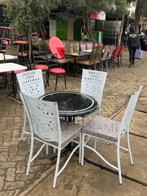 Black Round Marble Table And White Coated Chairs