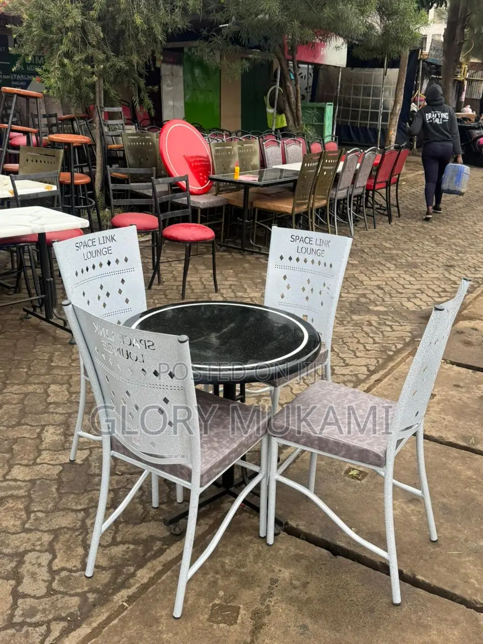 Black Round Marble Table And White Coated Chairs