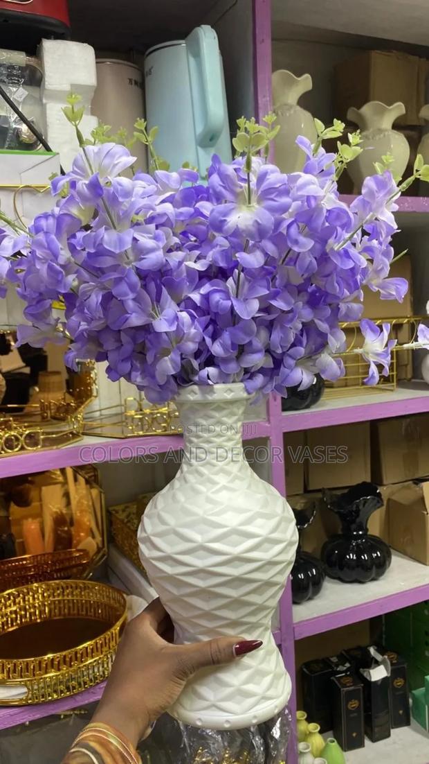Purple Flowers in Big White Plastic Vase