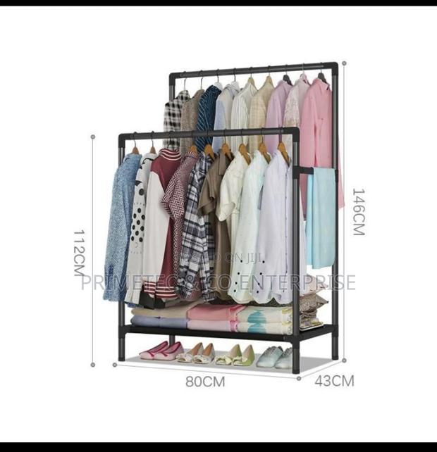 Double Pole Clothing Rack With Lower Storage Shelf.