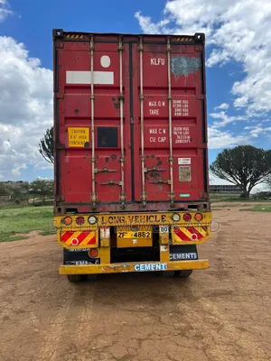 Containerized Trailer Accessible for Loose Cargo Transport