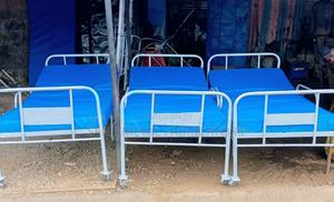 Hospital Bed With Adjustable Headrest and a Mattress. - main view