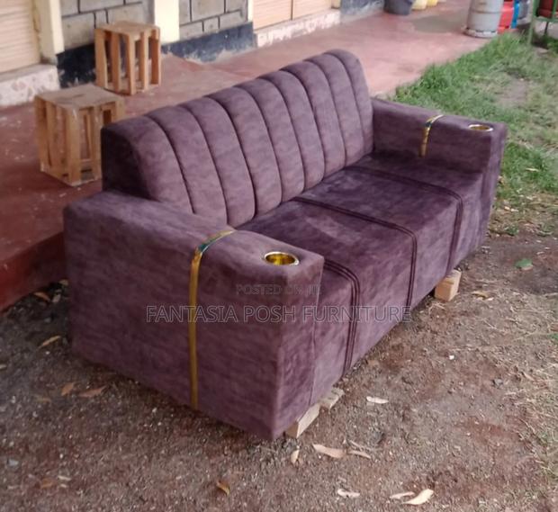Brown Sofa With Cup Holders and Gold Accents