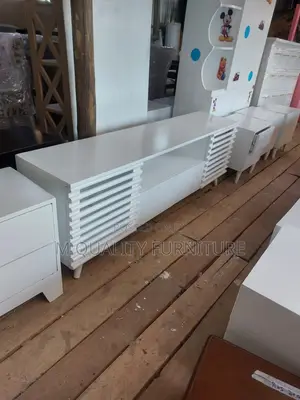 A Wooden Tv Stand With Open Shelving