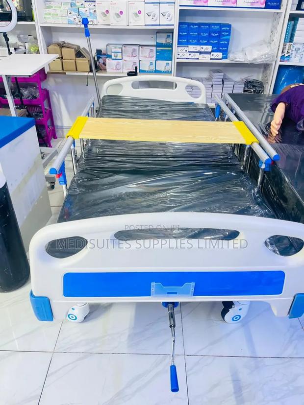Single Crank Hospital Bed With Overbed Table.