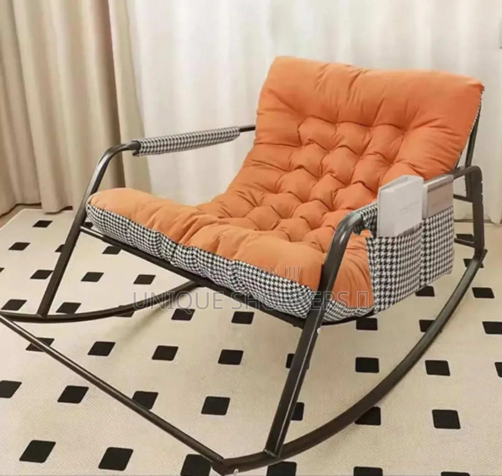 Rocking Chair With an Orange, Tufted Cushion