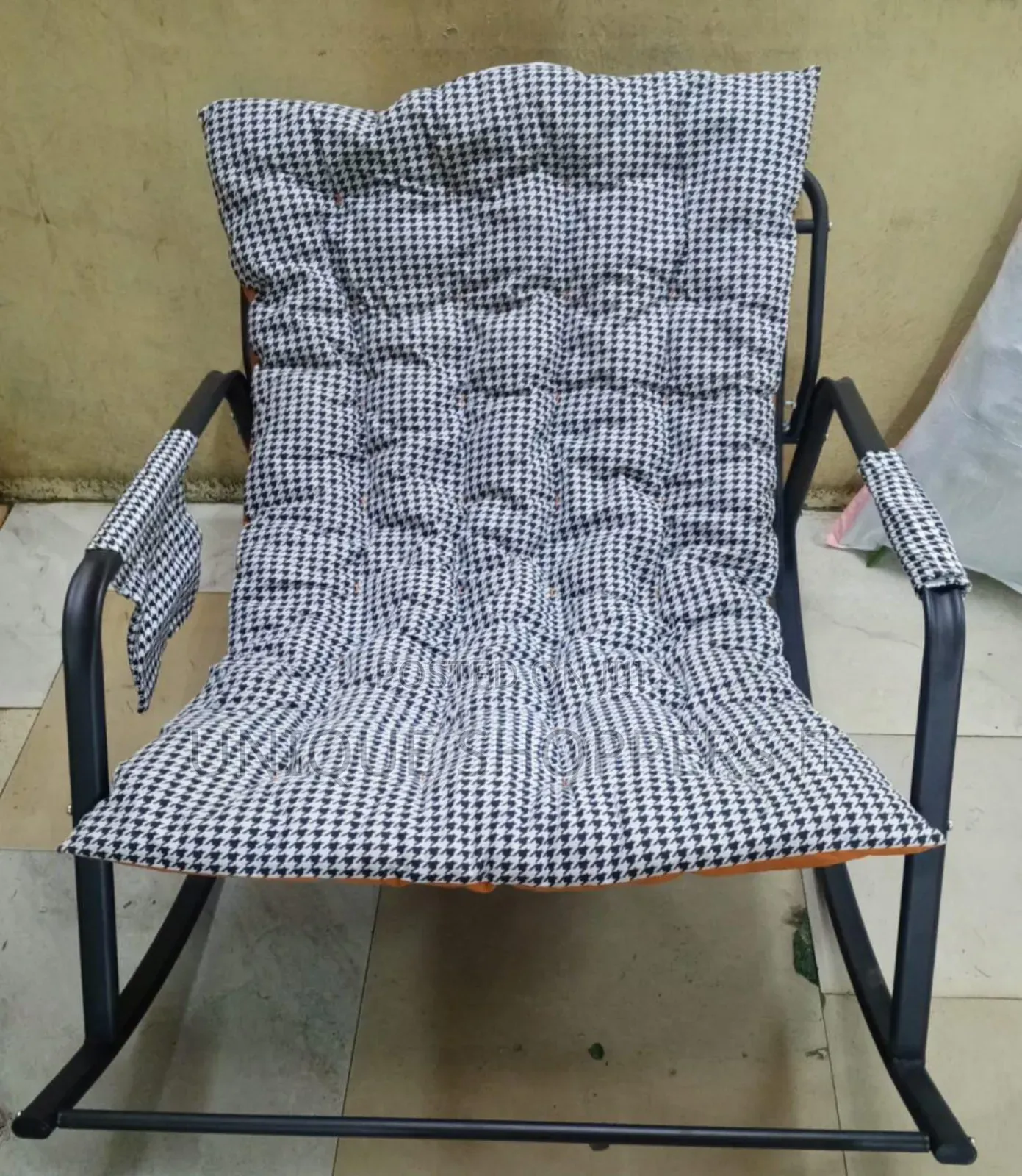 Rocking Chair With an Orange, Tufted Cushion