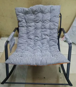 Rocking Chair With an Orange, Tufted Cushion