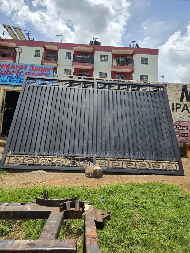 Modern Black Sliding Gate With Golden Detailing - main view