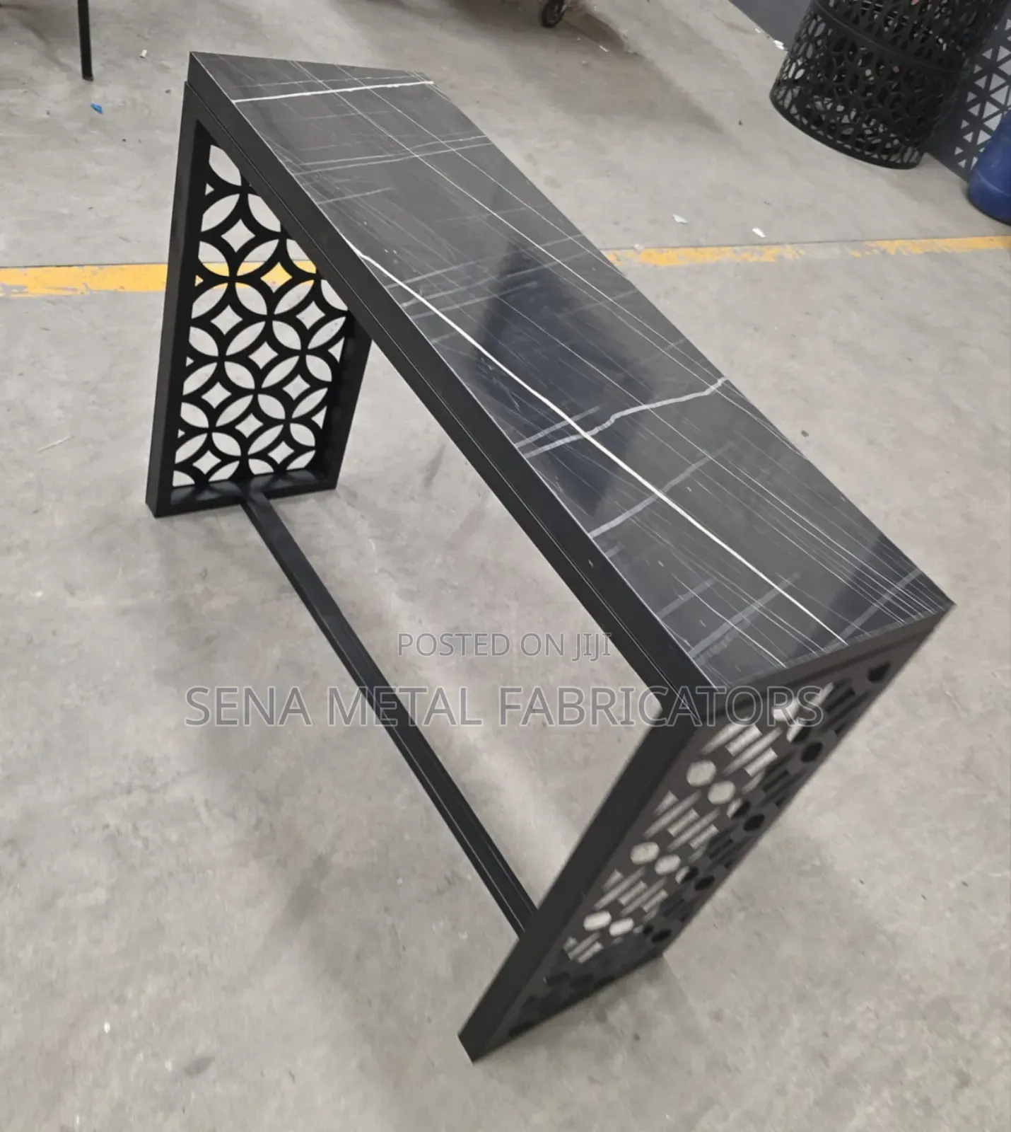 Black Rectangle Console Table With Laser-Cut Designs.