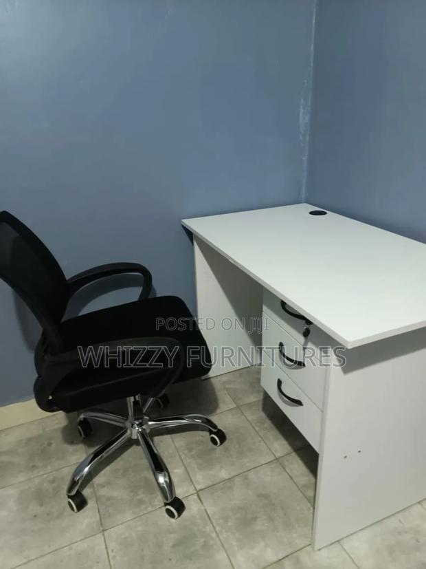 White Office Desk With a Black Ergonomic Office Chair