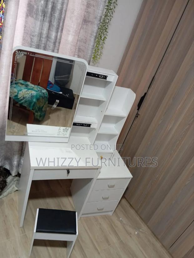 Dressing Table With a Mirror, Multiple Drawers and Shelves