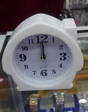 Alarm Clock. White, House-Shaped Quartz Analog Alarm Clock.
