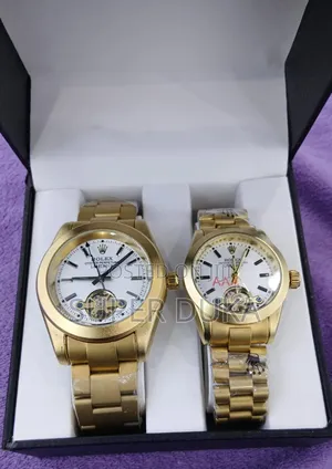 Two Gold-Toned Watches With White Dials. Wrist Watch