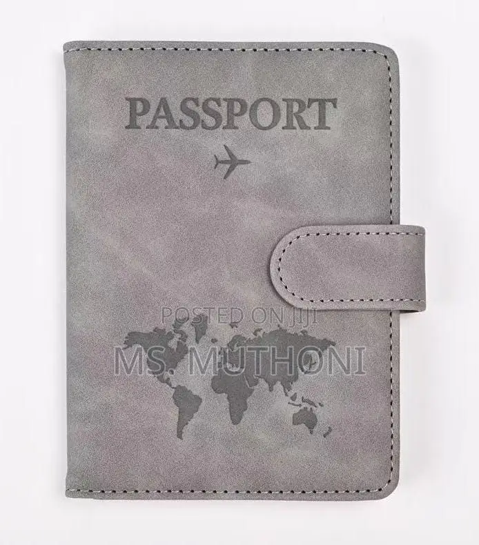 Passport Holder With a World Map Design and a Snap Closure.