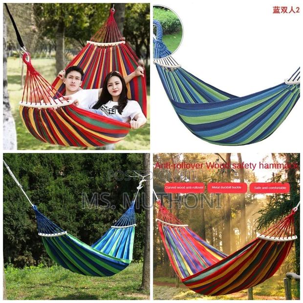 Blue and Green Striped Canvas Hammock With Spreader Bars. - main view
