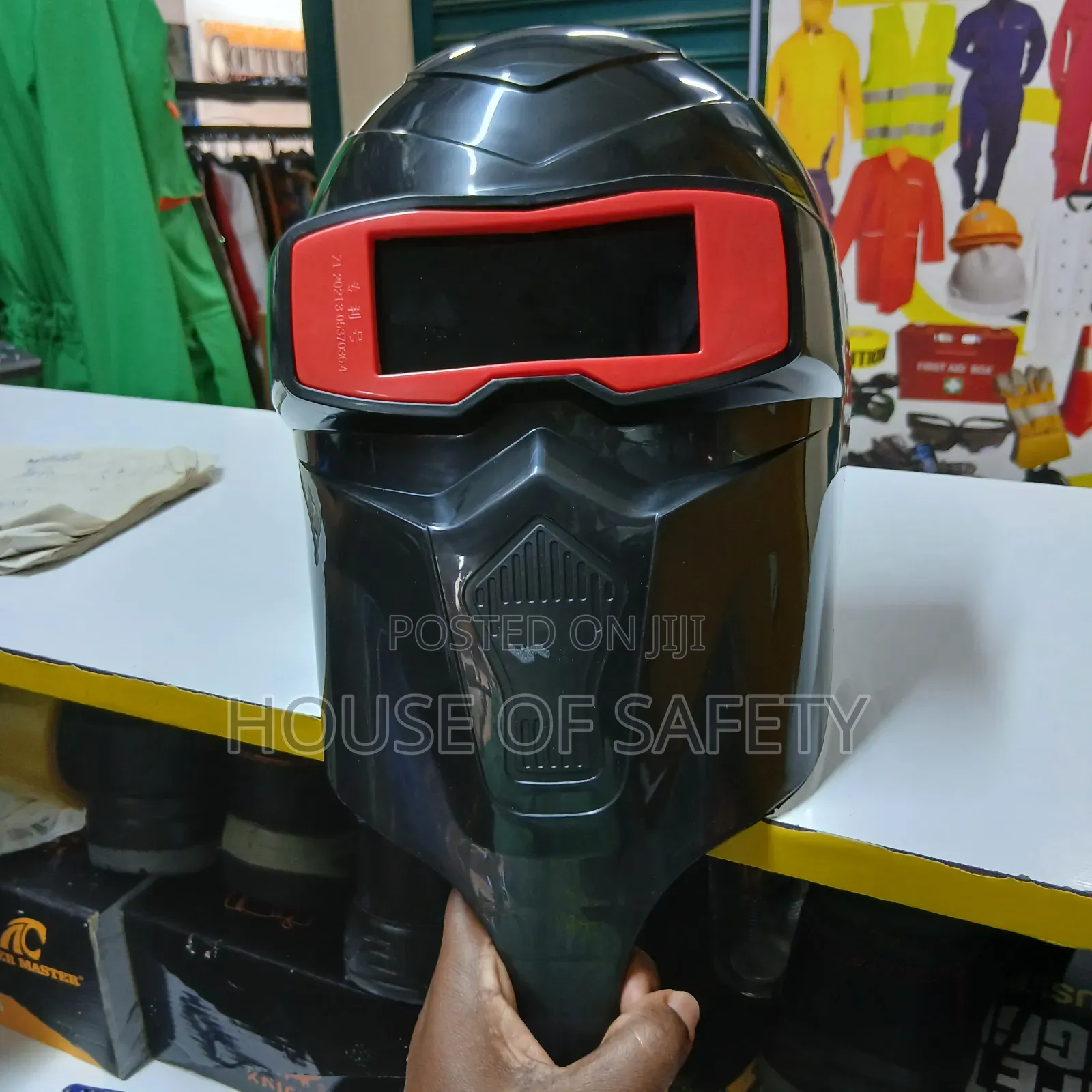 Black Welding Helmet Held By Hand