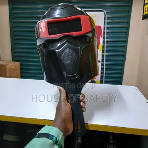 Black Welding Helmet Held By Hand