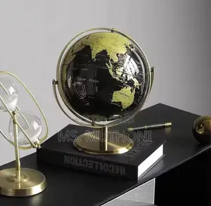 Black and Gold Rotating World Globe With a Metal Stand.