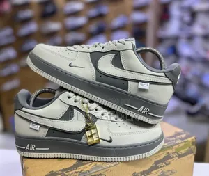Nike Air Force 1 Low Sneakers in a Grey and Off-White Colorway.