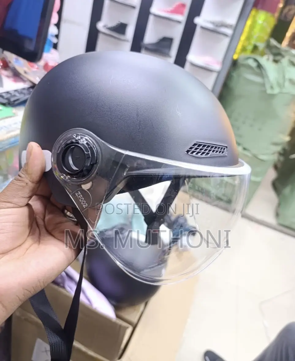 Black Motorcycle Half Helmet With A Clear Visor.