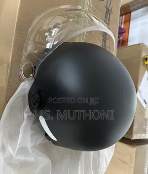 Black Motorcycle Half Helmet With A Clear Visor.