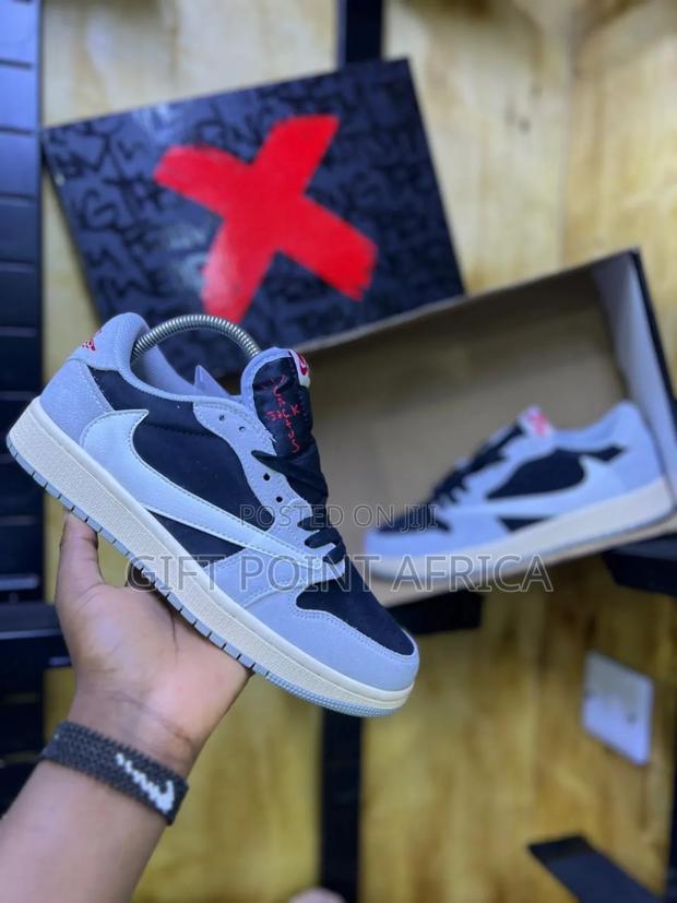 Nike Air Jordan 1 Low Travis Scott In A Black And Grey Colorway.