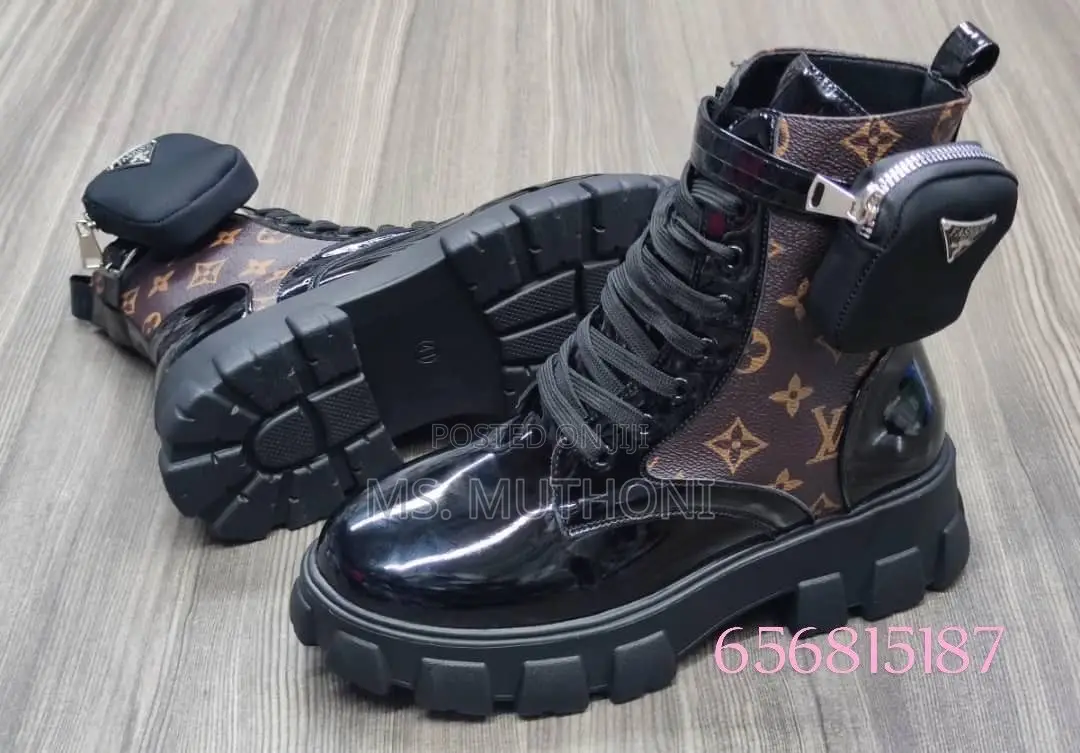 Black Patent Leather Prada Monolith Boots With a Detachable Pouch.