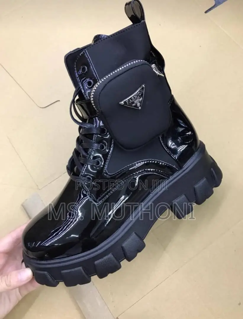 Black Patent Leather Prada Monolith Boots With a Detachable Pouch.