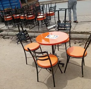 Branded Restaurant/Hotel Table With Orange Chairs.