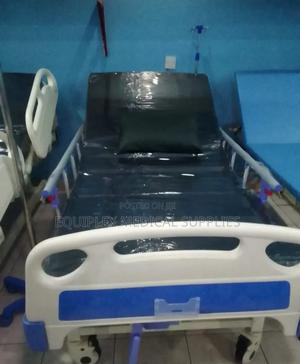 Single Crank Hospital Bed With Mattress, Mackintosh, and a Drip Stand