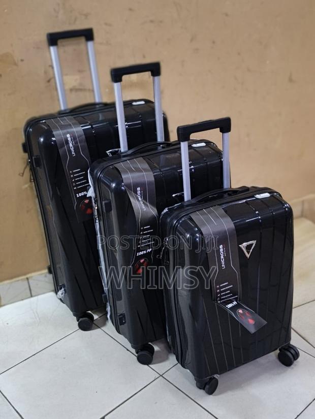 A Set of Three Unicross Unbreakable Rubber Suitcases - thumbnail 2