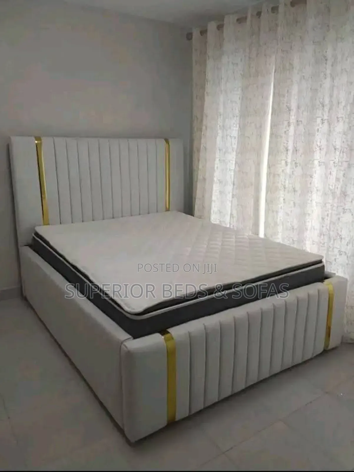 5 by 6 White Upholstered Bed With Gold Accent Headboard