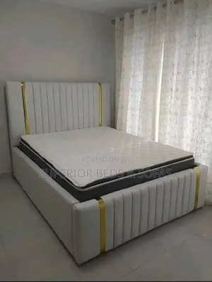 5 by 6 White Upholstered Bed With Gold Accent Headboard