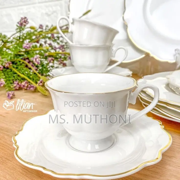 White 12-Piece Porcelain Tea Set With Gold Trim.