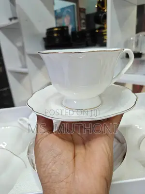 White 12-Piece Porcelain Tea Set With Gold Trim.