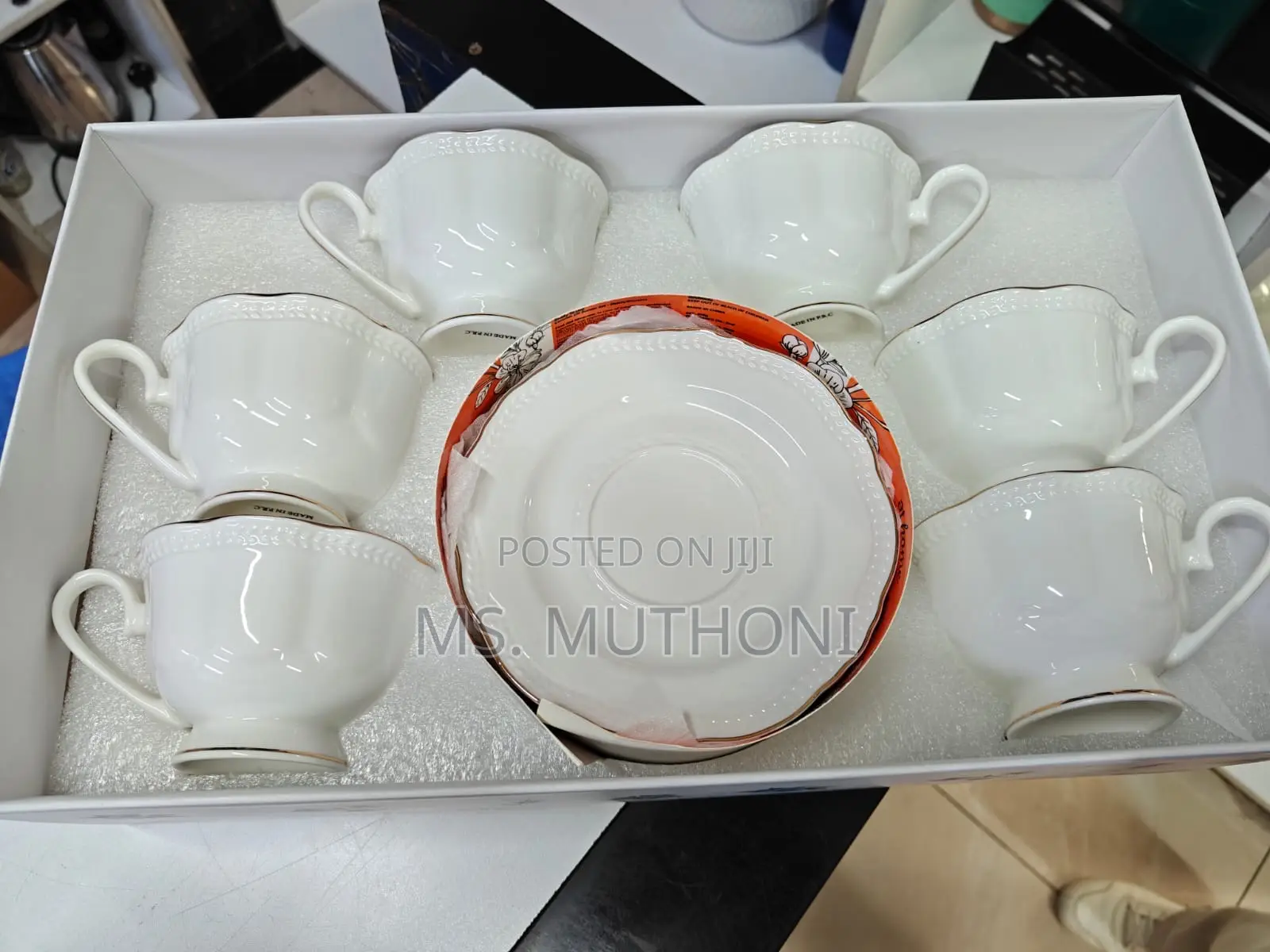 White 12-Piece Porcelain Tea Set With Gold Trim.