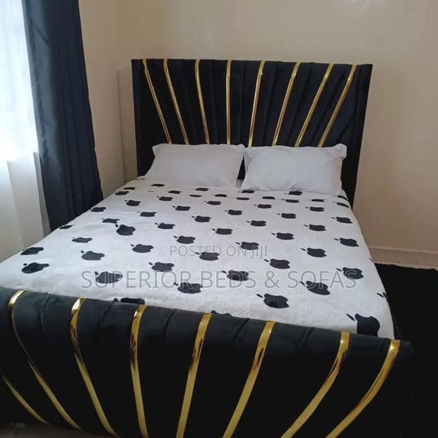 Upholstered Bed With Gold Accents