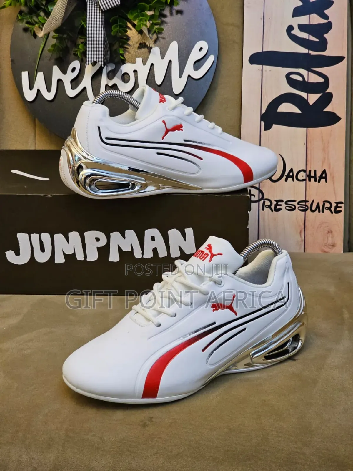 White And Red Puma Sneakers With Silver Accents.