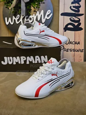 White And Red Puma Sneakers With Silver Accents.