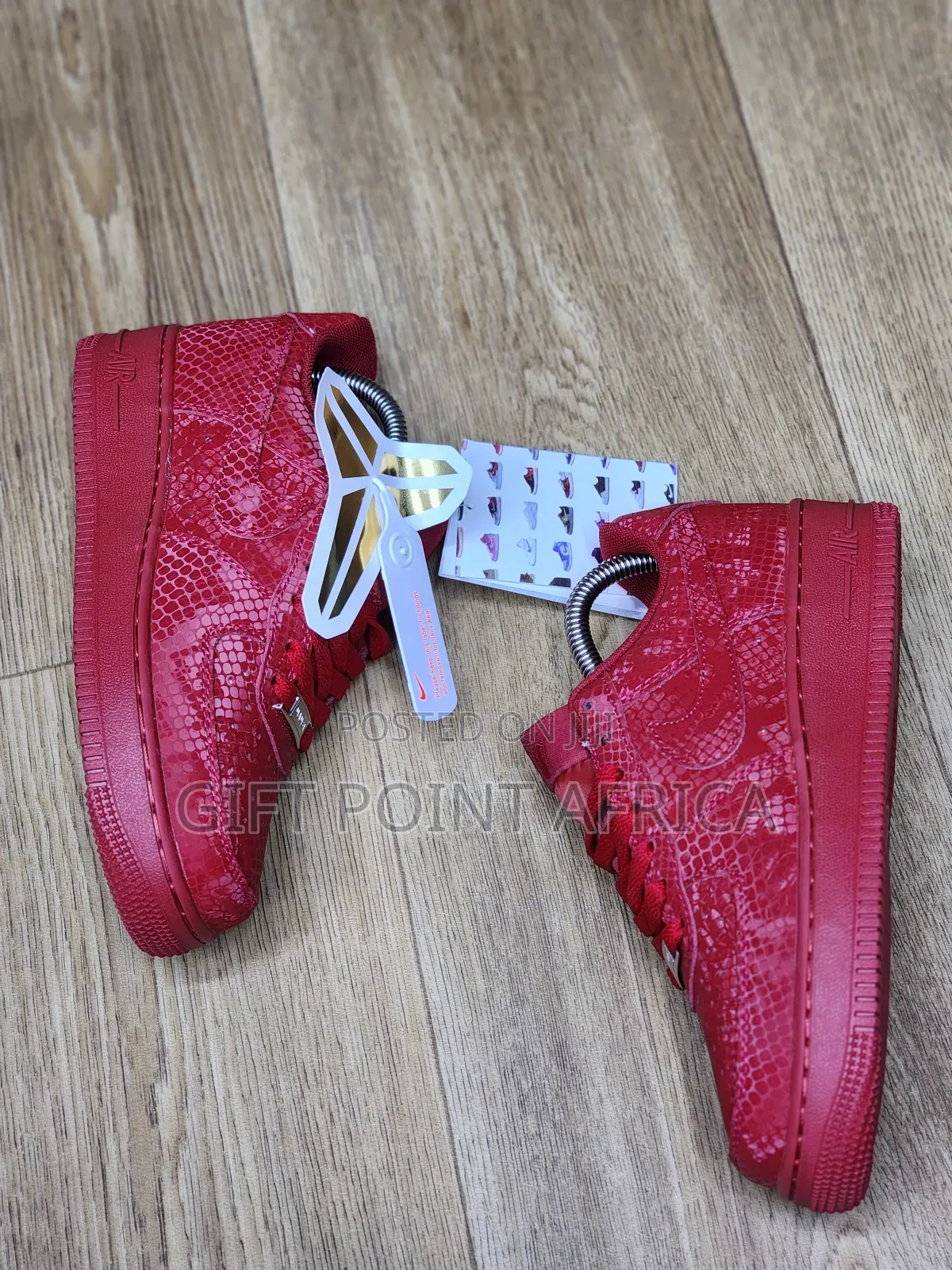 Red Nike Air Force 1 Low Basketball Shoes With A Snakeskin Pattern.