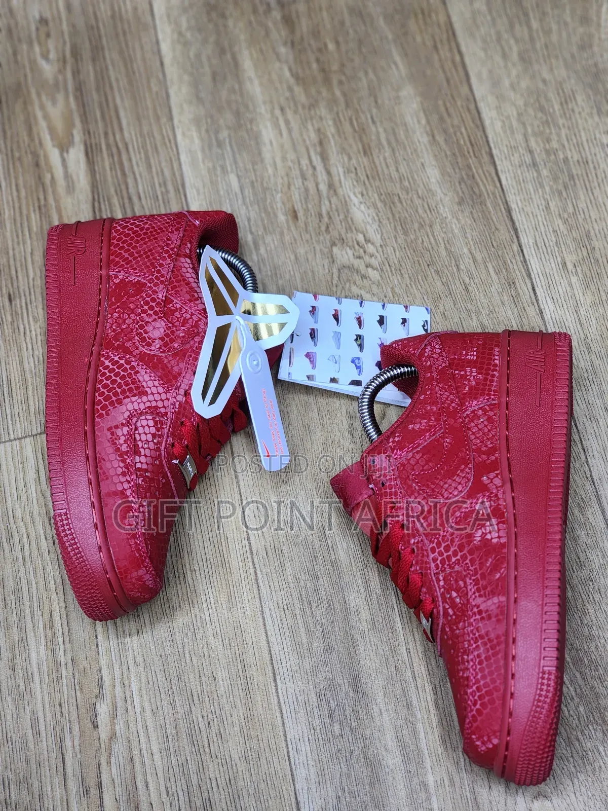 Red Nike Air Force 1 Low Basketball Shoes With A Snakeskin Pattern.