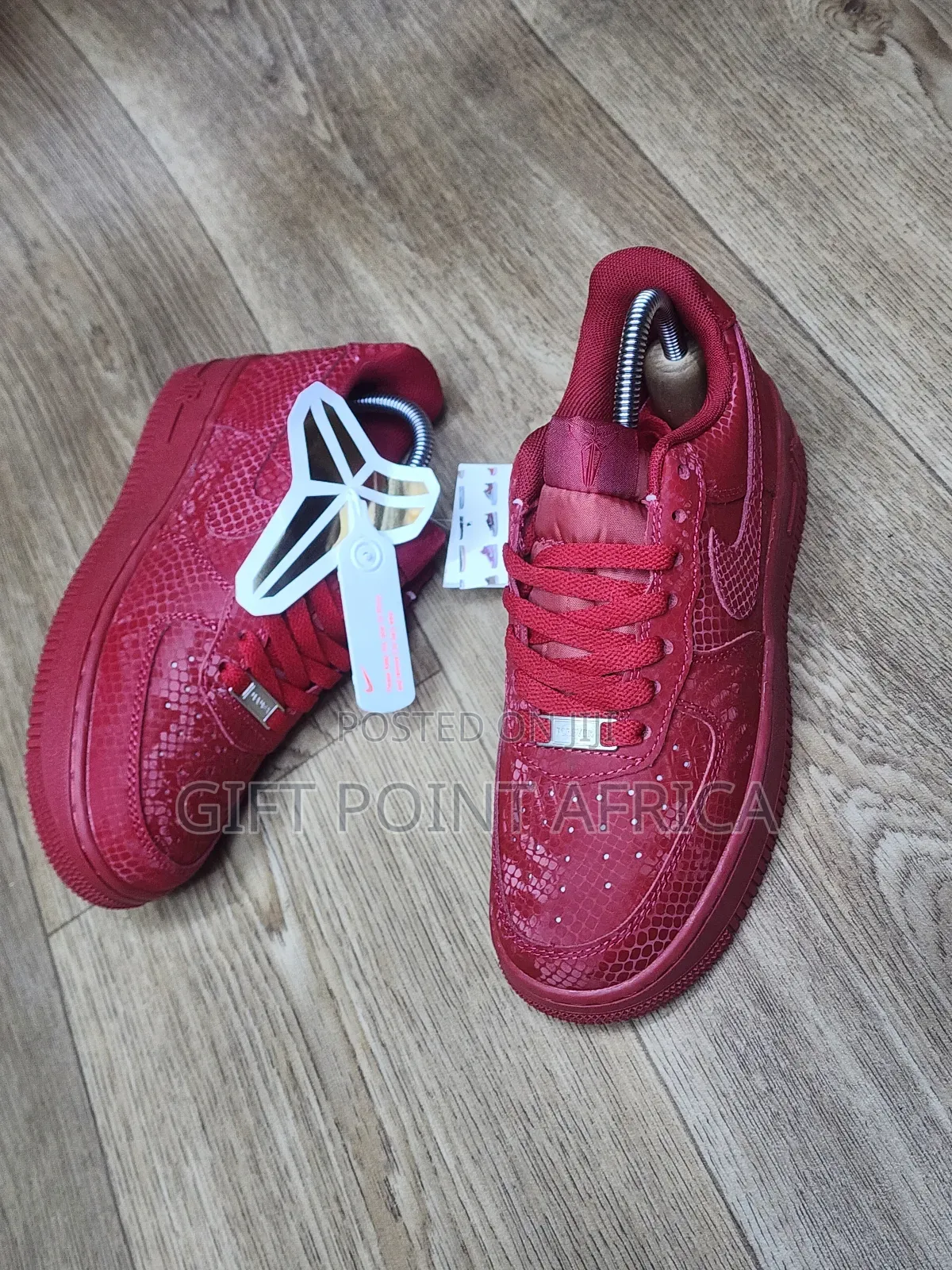 Red Nike Air Force 1 Low Basketball Shoes With A Snakeskin Pattern.