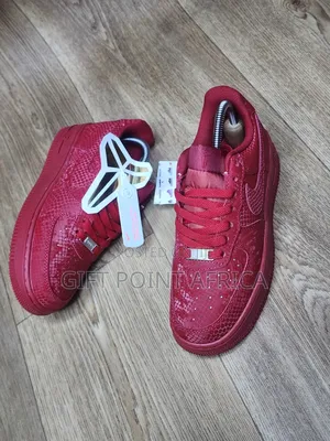 Red Nike Air Force 1 Low Basketball Shoes With A Snakeskin Pattern.