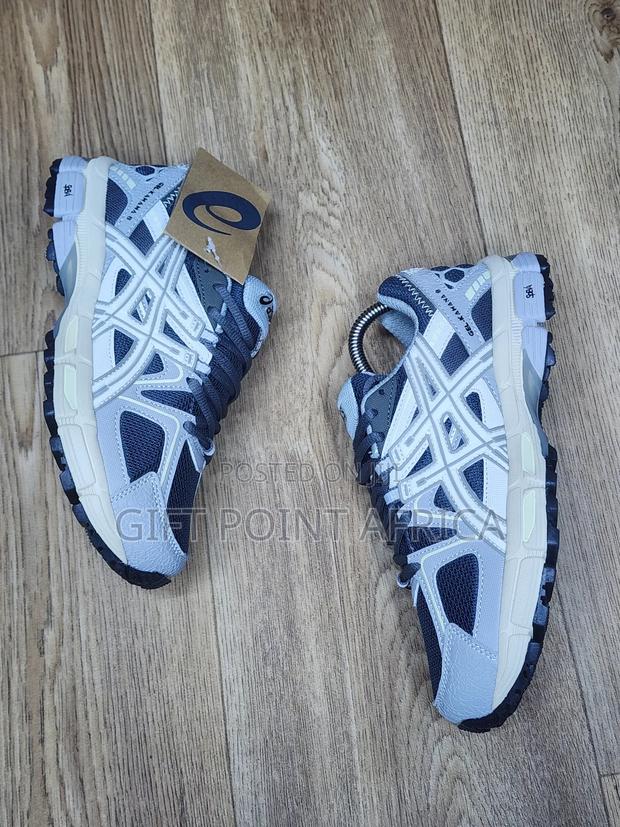 An Asics Gel-kahana 8 Sneaker, Likely In A Grey And White