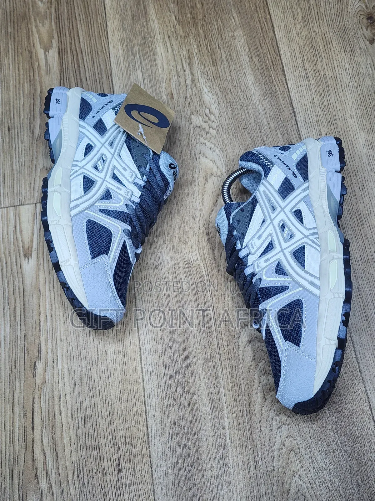 An Asics Gel-kahana 8 Sneaker, Likely In A Grey And White