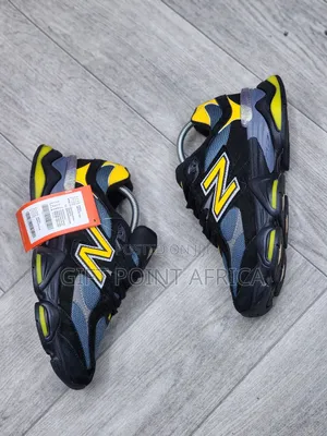 New Balance 9060 Sneakers In A Black, Grey, And Yellow